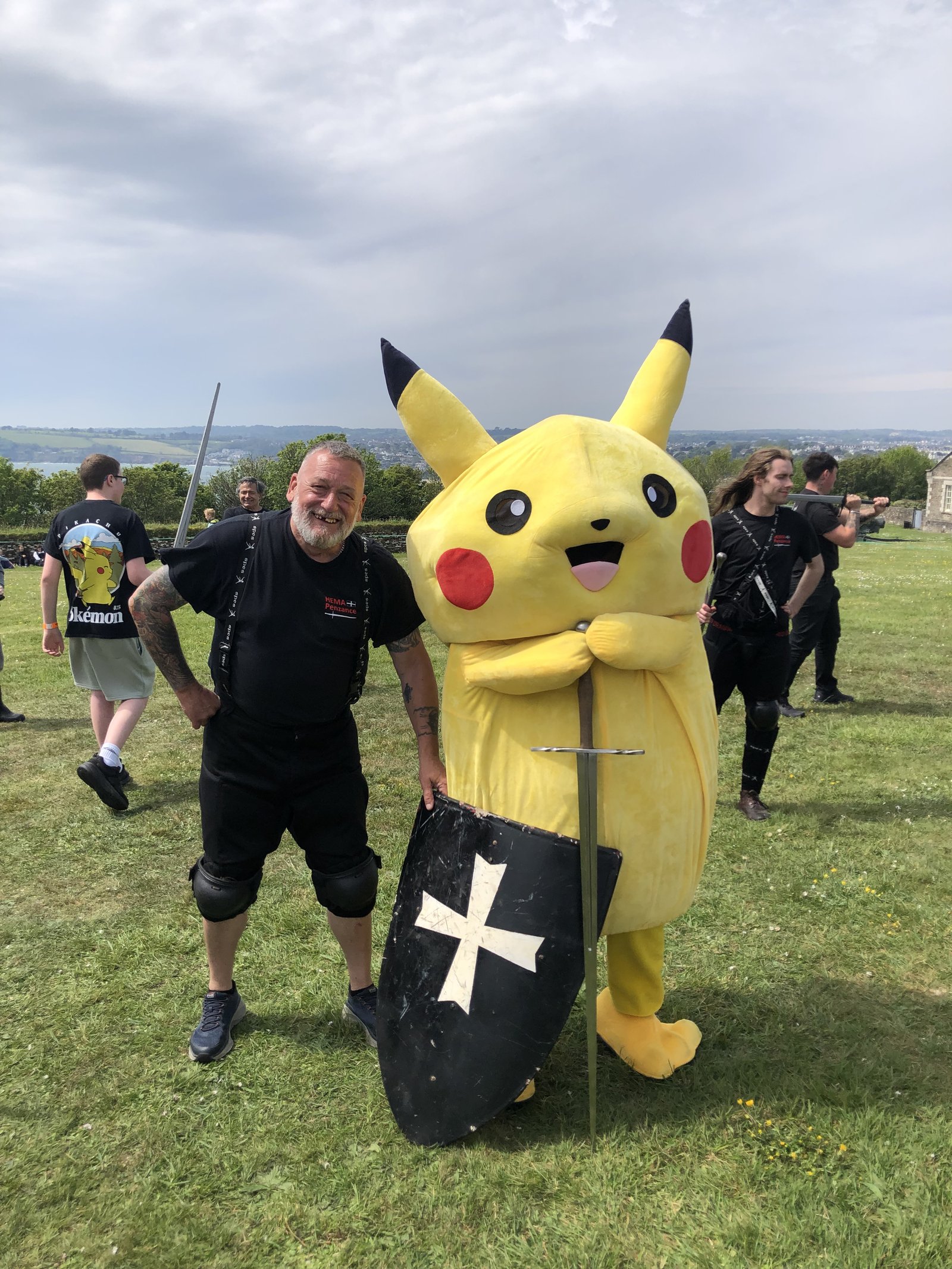 Steve with a Pikachu-costumed festival-goer holding a Cornish flag shield at FABLEFUSION