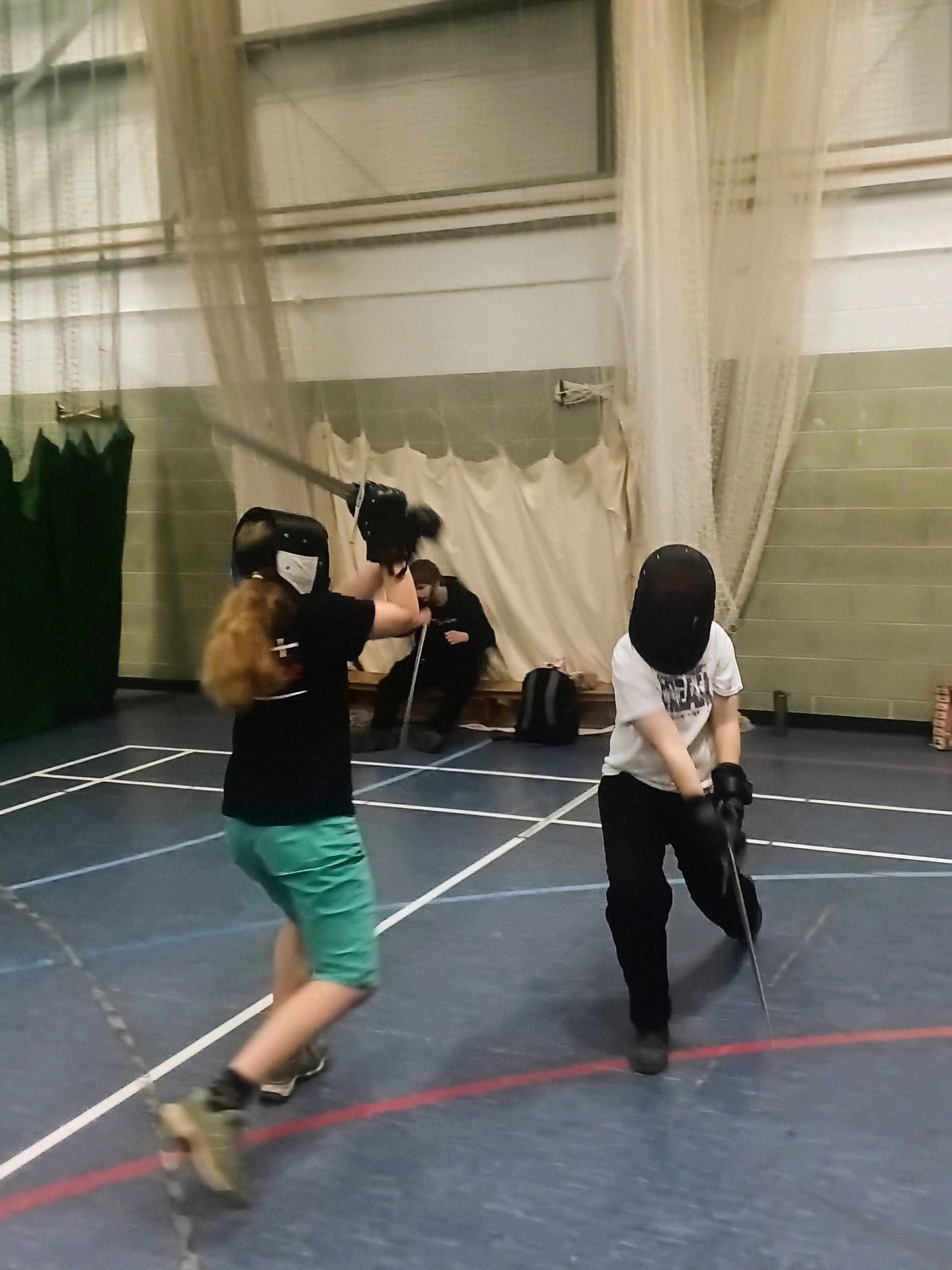 Younger members sparring with fencing masks